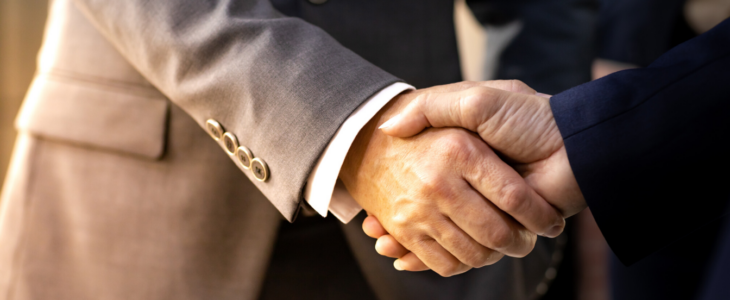 ||Handshake by business men over business purchase.